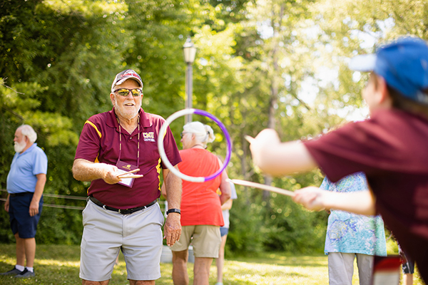 Grandparents playing games outdoor during event.