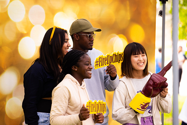 CMU students posing for photos together on campus.