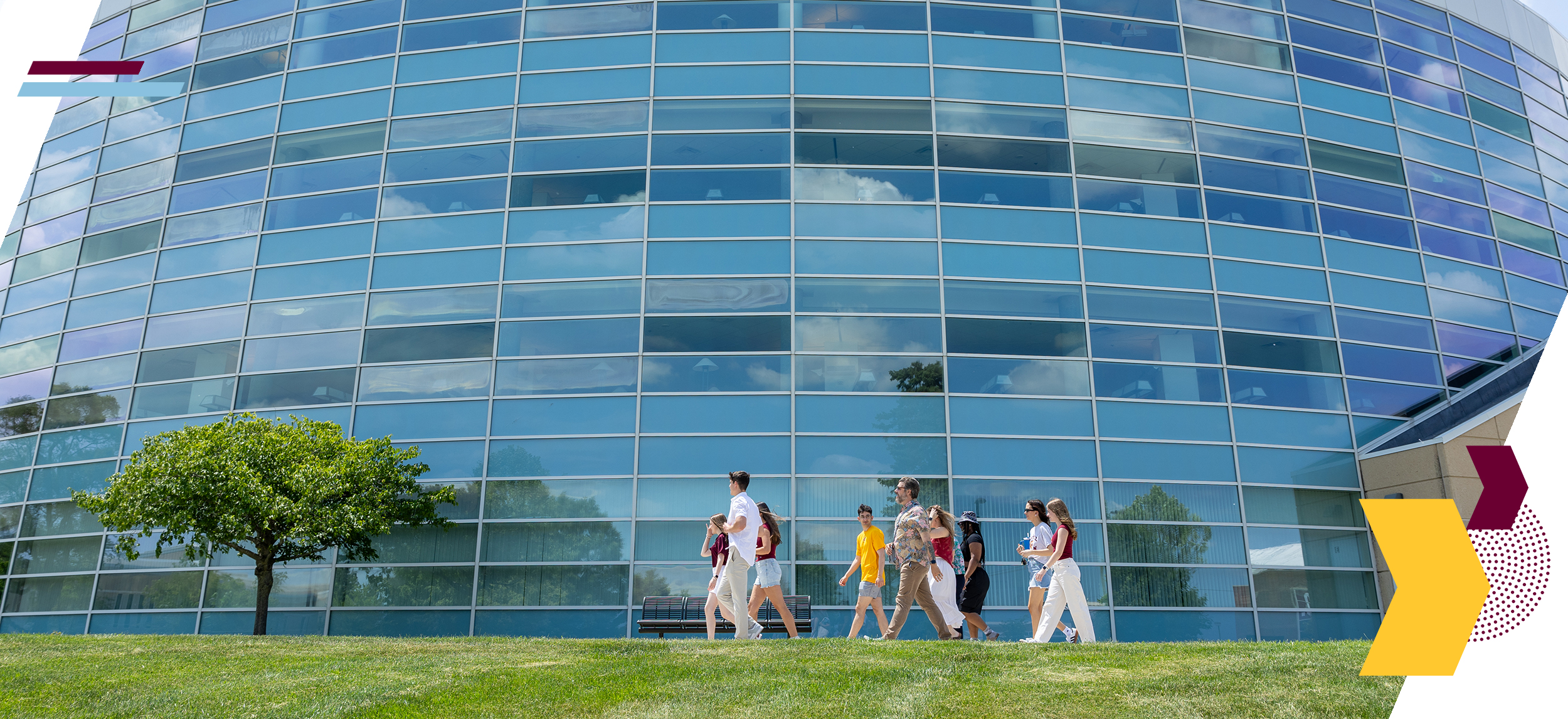 A group of students and family members stroll past the exterior of Park Library.  